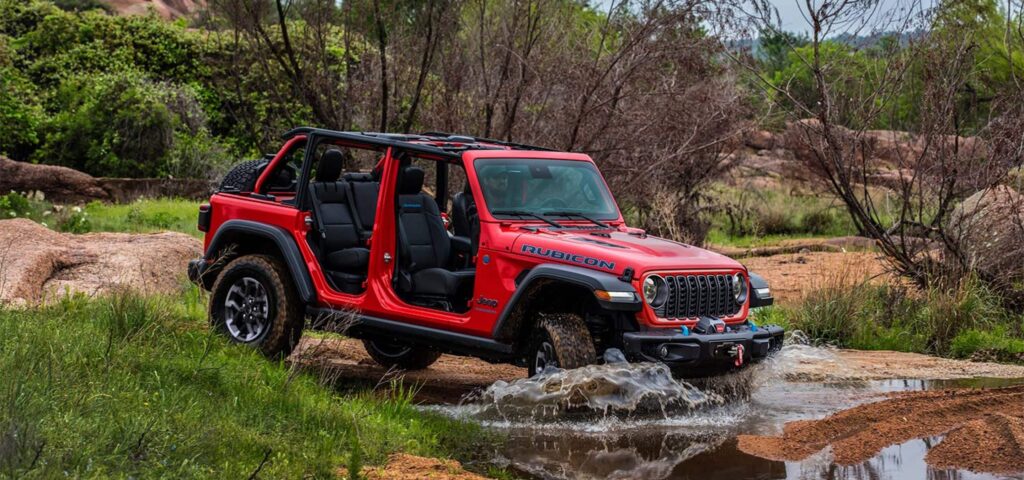 A red 2025 Jeep Wrangler off-roading in Maryland